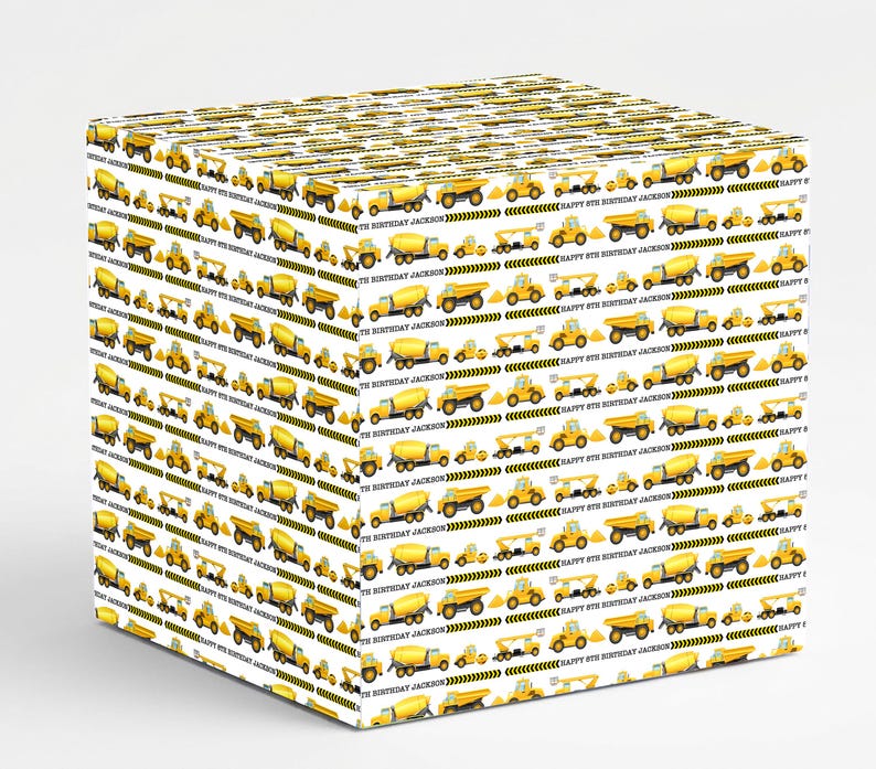 May include: White gift box wrapped in paper with a repeating pattern of yellow construction vehicles. The design includes dump trucks, cement mixers, and excavators. Text reads "HAPPY 8TH BIRTHDAY JACKSON".