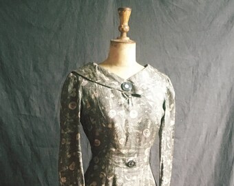 1950s hieroglyphics silk dress in olive green.