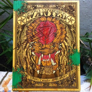 May include: A wooden sign with a vintage wanted poster design. The poster features a detailed illustration of a creature with sharp teeth and a red and yellow color scheme. The text on the poster reads "WANTED" and "Diablo Cazador de Hombres".