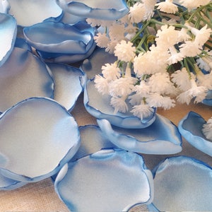 May include: A scattering of light blue satin rose petals, perfect for wedding decor or special events.