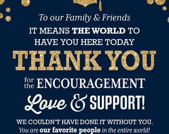 May include: A navy blue card with gold glitter confetti and a gold glitter graduation cap. The card says "To our Family & Friends IT MEANS THE WORLD TO HAVE YOU HERE TODAY THANK YOU for the ENCOURAGEMENT Love & SUPPORT! WE COULDN'T HAVE DONE IT WITHOUT YOU. You are our favourite people in the entire world! The Graduates"