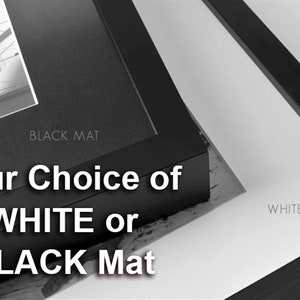 May include: Two framed images showing the option to choose a white or black mat. The text "Your Choice of WHITE or BLACK Mat" is displayed below the images.