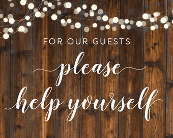 May include: A rustic wooden sign with white string lights hanging above it. The sign says "For our guests, please help yourself".