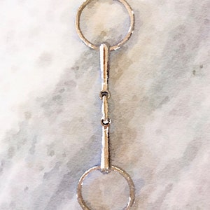 May include: A silver horse bit with two rings and a jointed mouthpiece.
