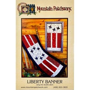 May include: A sewing pattern titled Liberty Banner by Mountain Patchwork. The image displays a fabric table runner and a wall hanging, both featuring red, white, and blue star and stripe patterns. The text Liberty is visible on both items.