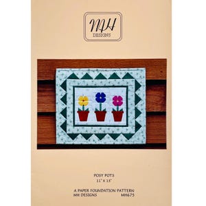 May include: A quilted square featuring three potted flowers in yellow, blue, and pink. The flowers are set against a white background with a green border. The pattern is 11" x 13" and is titled "Posy Pots". The MH Designs logo is at the top.
