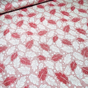 May include: Red and white fabric with a repeating pattern of leaves and dots. The leaves are white with red dots and the background is red with white dots.