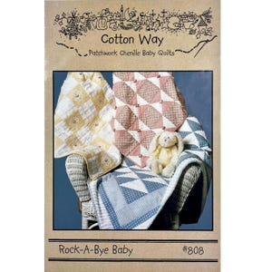 May include: A vintage sewing pattern for a baby quilt titled "Rock-A-Bye Baby" from Cotton Way Patchwork Chenille Baby Quilts. The pattern number is #808. The image shows three quilts in different colors and patterns, a stuffed bunny, and a wicker rocking chair.