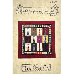 May include: A quilt pattern titled Tie One On by Robb-n-Graves Designs, model RG47. The design features a grid of twelve shirt blocks, each displaying a different necktie, surrounded by a multi-colored border and a solid dark red outer border.