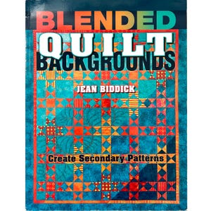 May include: A book titled "Blended Quilt Backgrounds" by Jean Biddick. The cover features a colorful quilt design with teal, orange, and yellow squares and patterns. The text "Create Secondary Patterns" is also visible.