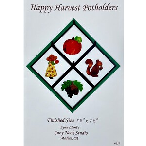 May include: A white background with a green diamond-shaped frame, featuring four squares with fall-themed illustrations. The top text reads "Happy Harvest Potholders." The finished size is 7.5" x 7.5". Includes an apple, squirrel, acorns, and a person.
