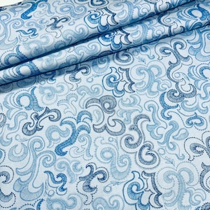 May include: Blue and white fabric with a swirling, paisley-like pattern. The fabric is soft and has a subtle sheen.