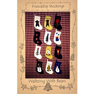 May include: A collection of twelve small, decorative stockings arranged in a grid on a red and black plaid background. Each stocking features unique appliqued designs including stars, hearts, trees, snowmen, and animals, with names embroidered on top.