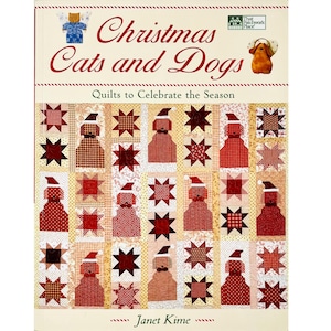 May include: A book cover titled "Christmas Cats and Dogs" with a quilt design featuring dogs in Santa hats and star patterns. The book is by Janet Kime and is about quilts to celebrate the season.
