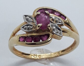 May include: A gold ring featuring a pink ruby gemstone surrounded by smaller pink rubies and white diamonds. The ring has a delicate floral design.