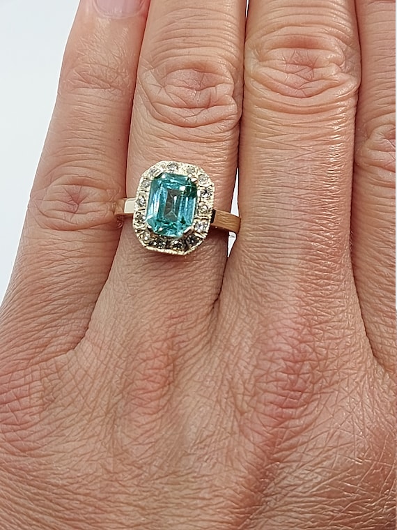 Round faceted blue topaz ring in silver prongs setting with sterling s