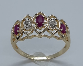 May include: A gold ring set with five oval-shaped gemstones. The centre stone is a larger ruby, flanked by two smaller rubies and two diamonds.