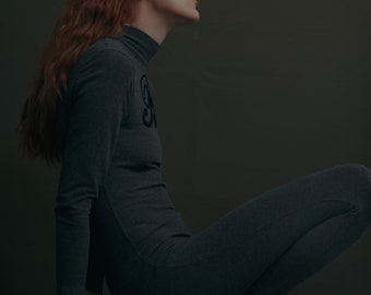 Blumarine Folies early 90's grey cotton mock neck long sleeves catsuit jumpsuit with black sequined logo and stirrup leg (S)