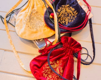 Handcrafted in India embroidered velvet drawstring reversible pouch bags available in red, yellow and blue boho hippie style