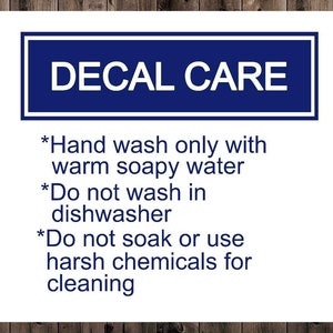 May include: A white sign with blue text that reads "DECAL CARE" and instructions for cleaning decals. The instructions are: "Hand wash only with warm soapy water", "Do not wash in dishwasher", and "Do not soak or use harsh chemicals for cleaning."