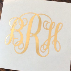May include: Gold monogram decal with the letters "BRH" in a cursive font.