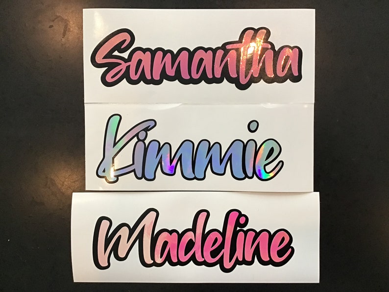 May include: Three white labels with names written in black and pink holographic lettering. The names are Samantha, Kimmie, and Madeline.