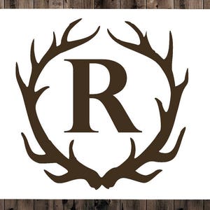 May include: A brown silhouette of an antler design with the letter "R" in the center.