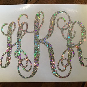 May include: A silver glitter monogram decal with the letters "HKR" in a cursive font.