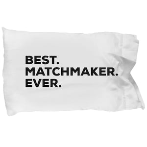 May include: White pillow with black text that reads "BEST. MATCHMAKER. EVER."