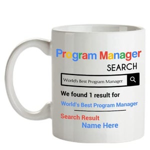 May include: White ceramic coffee mug with a Google search bar design. The text reads "Program Manager Search" and "We found 1 result for World's Best Program Manager". The search result is "Search Result Name Here".