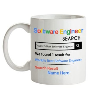 May include: White ceramic mug with a Google search bar design. The text reads "Software Engineer SEARCH" and "World's Best Software Engineer". The search results show "We found 1 result for World's Best Software Engineer" and "Search Result Name Here".