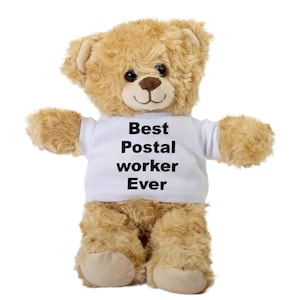 May include: A brown teddy bear wearing a white t-shirt with the text "Best Postal worker Ever" printed in black.