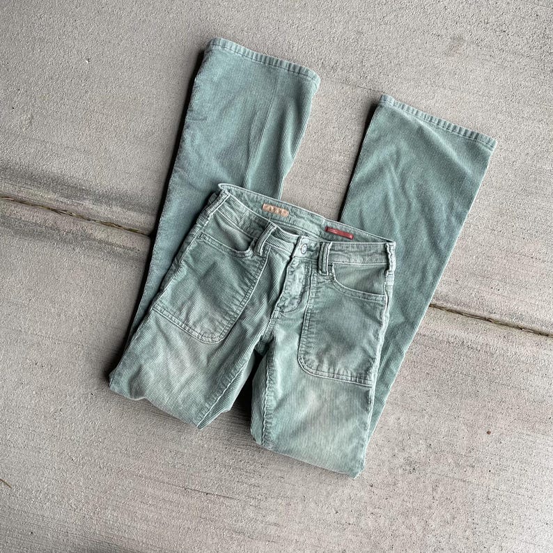 May include: A pair of green corduroy pants with a wide leg and a front pocket detail. The pants are made of a soft, comfortable fabric and have a relaxed fit.
