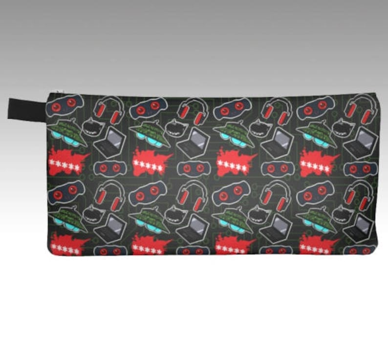 May include: Black pencil case with a repeating pattern of red, green, and black. The pattern includes headphones, laptops, and goggles.