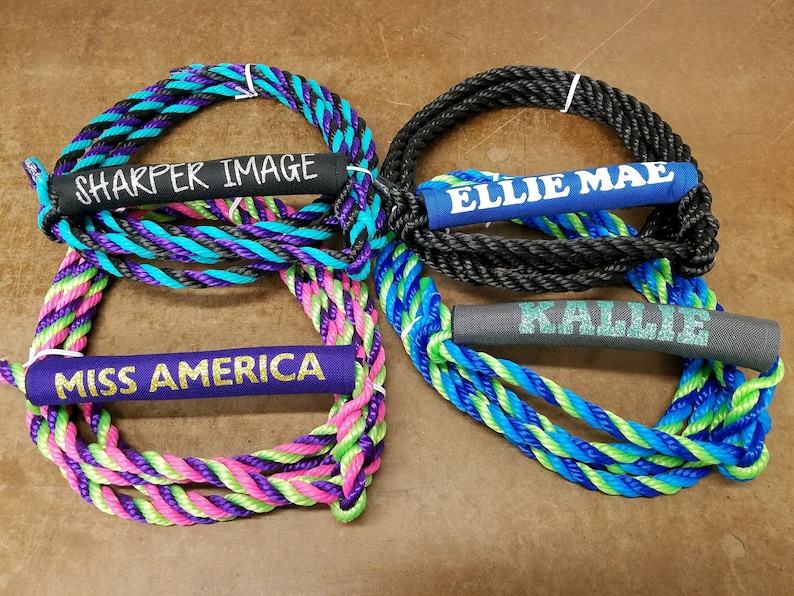 May include: Four colorful ropes with personalized names on the handles. The names are "Sharper Image", "Ellie Mae", "Miss America", and "Kallie".