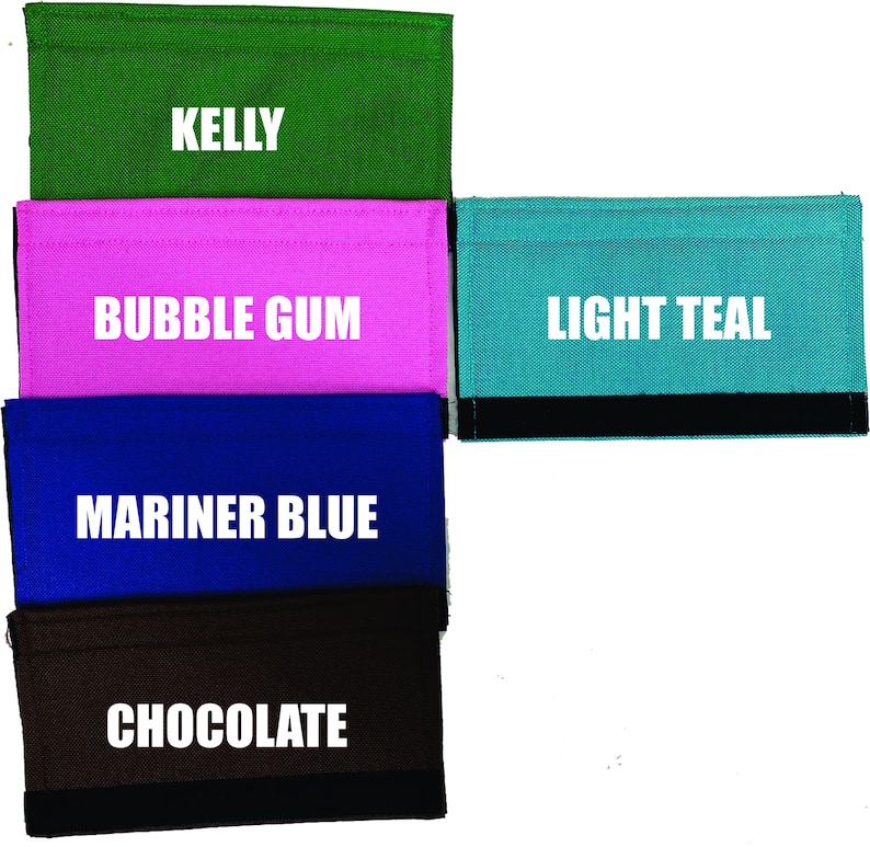 May include: Five different colored fabric wallets with black trim. The wallets are labeled "Kelly", "Bubble Gum", "Light Teal", "Mariner Blue", and "Chocolate".