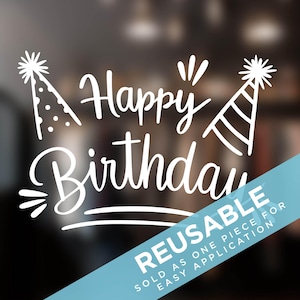 May include: White vinyl decal with the text "Happy Birthday" in a handwritten font. Two party hats are on either side of the text. The decal is on a blurred background and has a blue and white reusable sticker on the bottom right corner that says "Reusable, Sold as one piece for easy application."