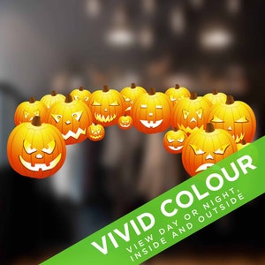May include: A group of orange jack-o'-lantern pumpkins with carved faces, arranged in a semi-circle. The pumpkins are on a blurred background with a green banner that says "VIVID COLOUR, VIEW DAY OR NIGHT, INSIDE AND OUTSIDE".