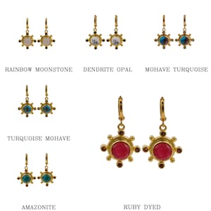 May include: Assortment of gold earrings with various gemstone colors, including rainbow moonstone, dendrite opal, turquoise, ruby, and amazonite. Each earring features a sunburst design with a central gemstone.