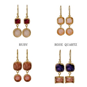 May include: Gold-toned drop earrings featuring a square gemstone above a round gemstone. The earrings are available in ruby, rose quartz, strawberry quartz, and blue sapphire. The text "RUBY", "ROSE QUARTZ", "STRAWBERRY QUARTZ", and "BLUE SAPPHIRE" are below each pair.