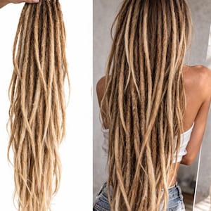 May include: A set of blonde and brown dreadlocks, with a gradient effect from darker roots to lighter tips. The dreadlocks are shown in a bundle and also styled on a person, showcasing the hair's length and texture. The hair appears to be synthetic.