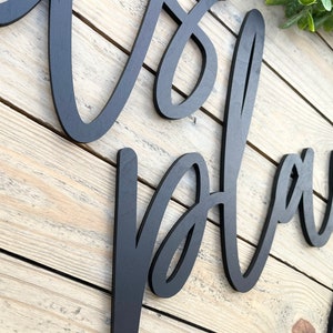 May include: Black wooden sign with the words "It's a Playdate" written in a cursive font.