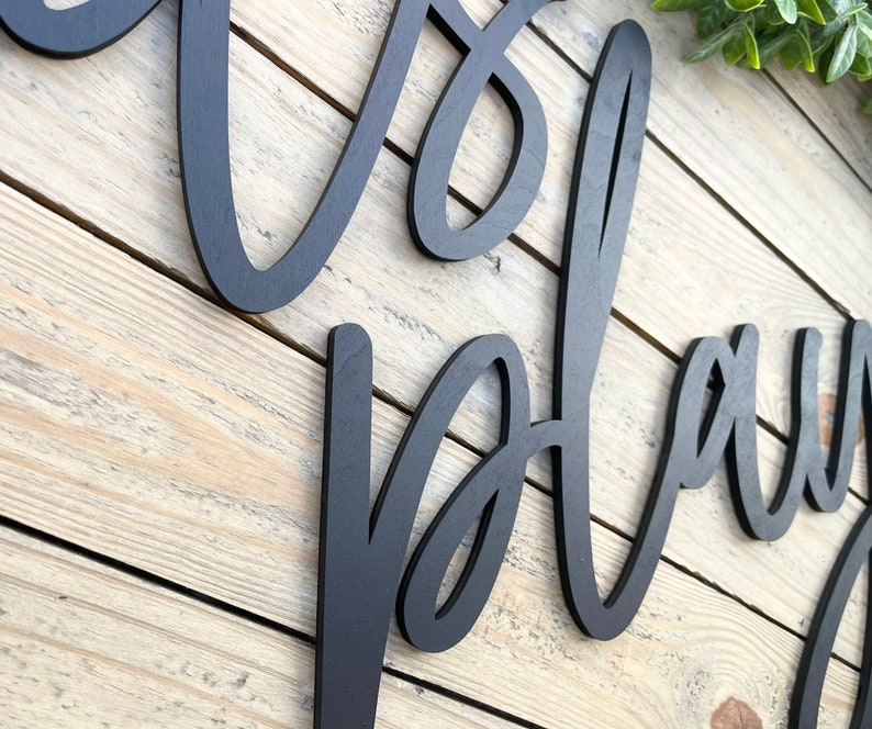 May include: Black wooden sign with the words "It's a Playdate" written in a cursive font.