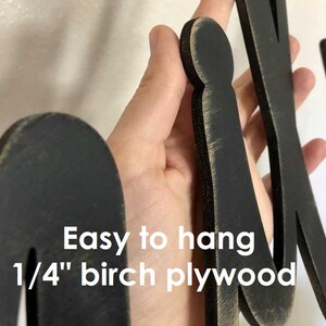 May include: Black wooden letters spelling "Mix" with a distressed finish. The letters are 1/4 inch thick birch plywood and are easy to hang.