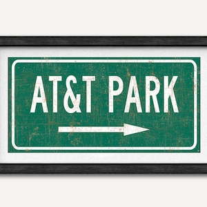 May include: A green and white vintage-style road sign with a white arrow pointing right and the text "AT&T PARK".