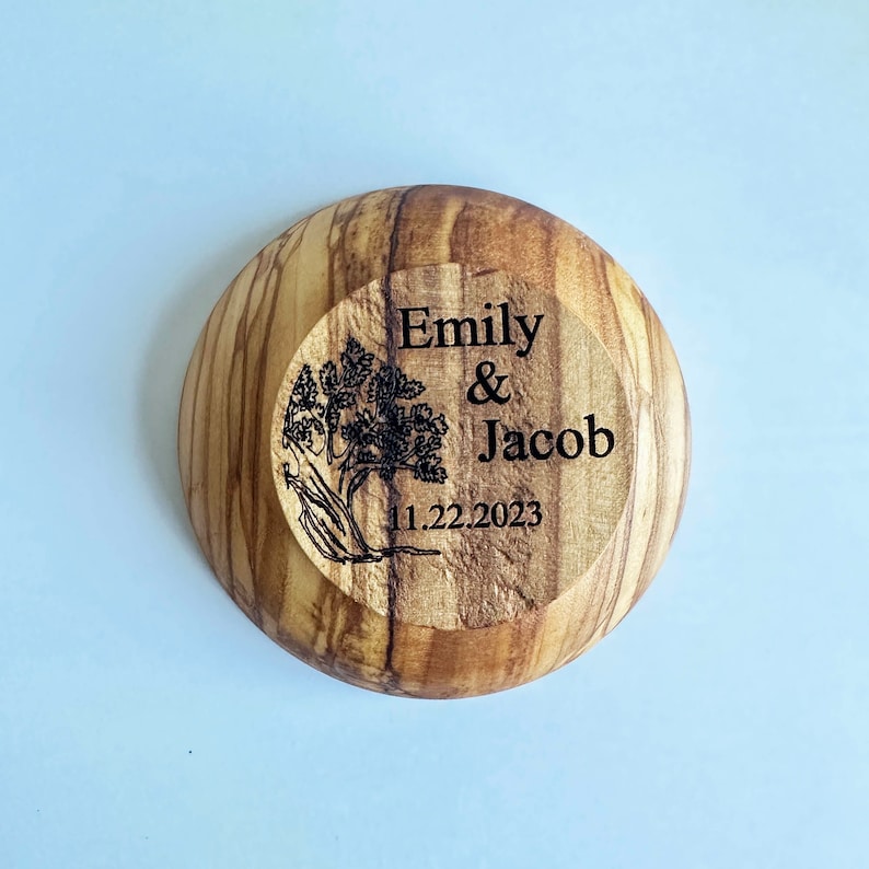 May include: A wooden bowl with a tree design and the text "Emily & Jacob 11.22.2023" engraved on the front.