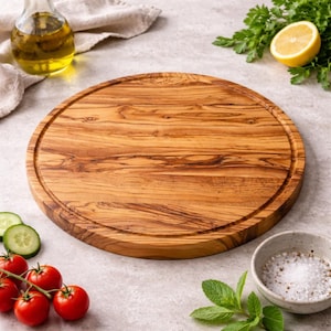 May include: A circular wooden chopping board with a carved edge. The board is made of light brown wood with a visible grain. Fresh ingredients, including tomatoes, cucumbers, and herbs, are arranged around the board, suggesting culinary use.