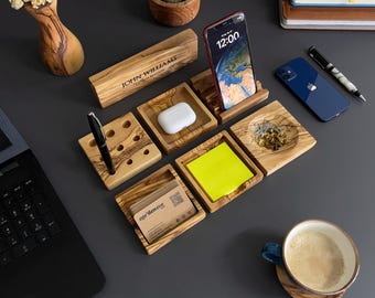 May include: Wooden desk organizer set with compartments for pens, business cards, and a phone stand. The set includes a small bowl for paper clips or other small items. The organizer is made of natural wood with a light brown finish. The phone stand has a digital clock display that reads 12:00.