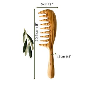 May include: A wooden comb with a wide tooth design, measuring 8 inches long and 2 inches wide. The comb is made of olive wood and has a natural wood grain pattern.