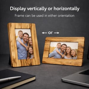 May include: Two wooden picture frames, one vertical and one horizontal, displaying a family photo. The frames are made of light-colored wood with a natural grain. Text at the top reads "Display vertically or horizontally".